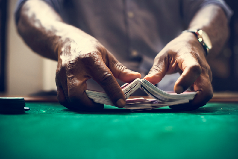 Man shuffling a deck of playing cards.